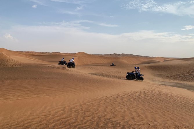 Dubai: Unique SUNSET Quad Bike Red Dunes Safari - Riding Into the Sunset: a Quad Bike Adventure